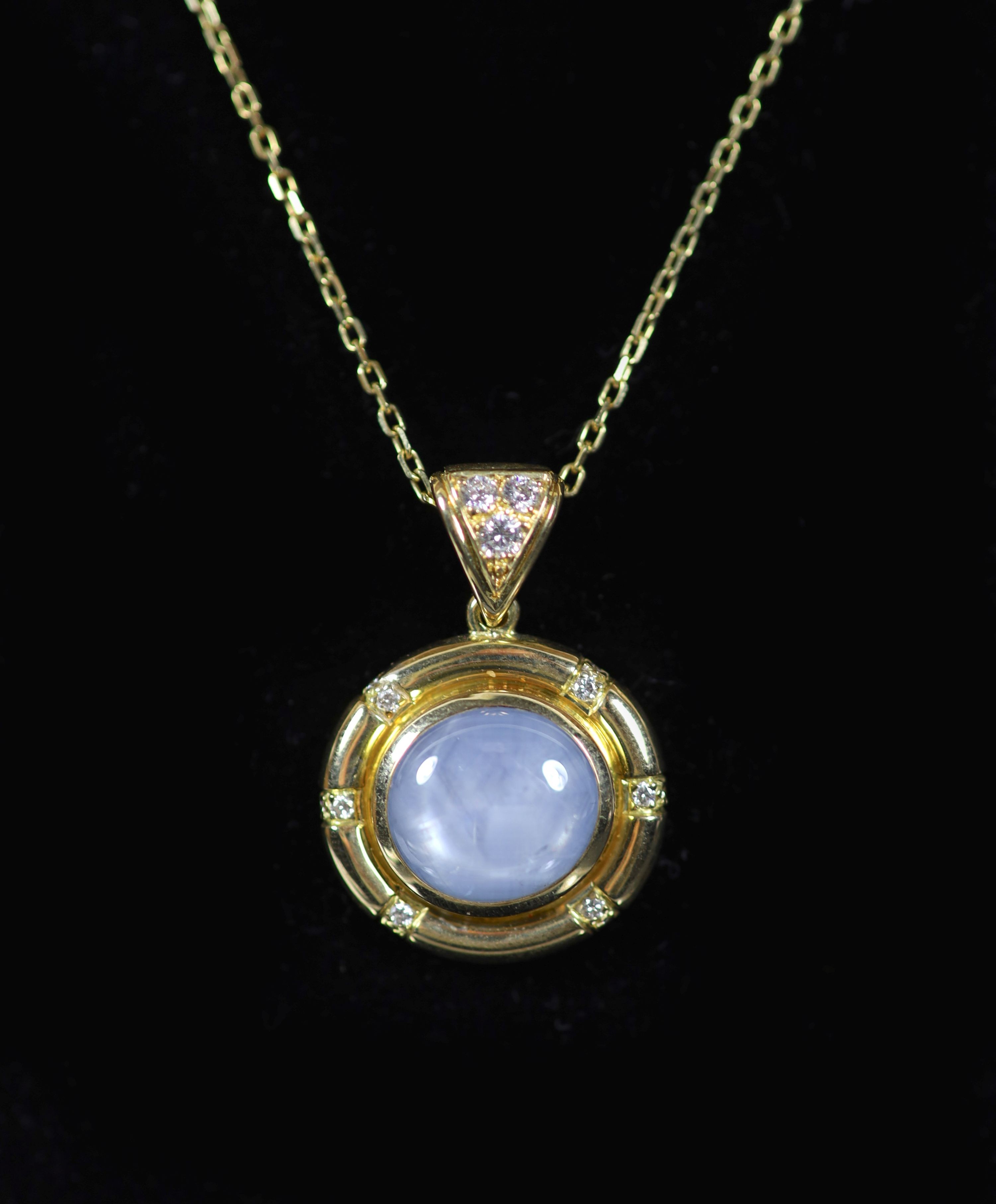 A 20th century French 18ct gold, cabochon star sapphire and diamond set circular pendant, on an 18ct gold fine link chain